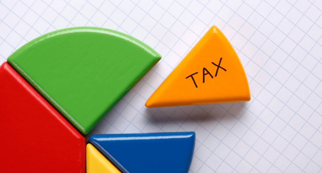 Four colorful geometric shapes form a partial pie chart on graph paper. A detached yellow triangle, labeled TAX, is separate from the red, green, and blue segments—ideal for accountants navigating MTD ITs complexities.