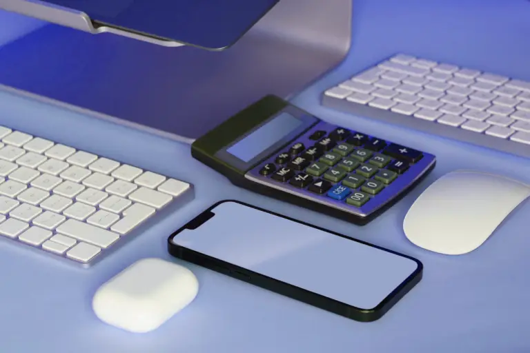 Desk with a keyboard, calculator, smartphone and mouse