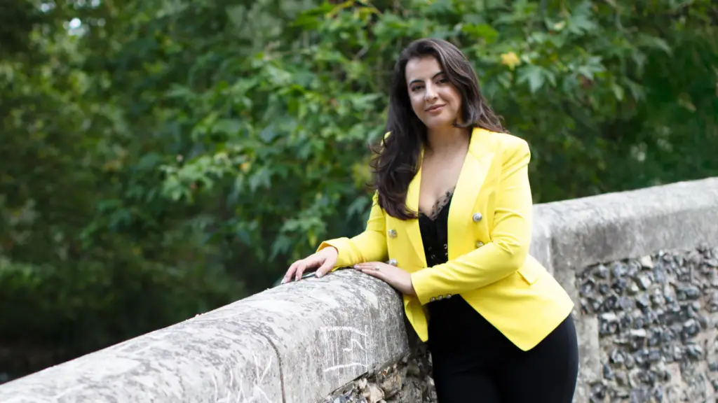 Eriona Bajrakurtaj outdoors in a yellow jacket
