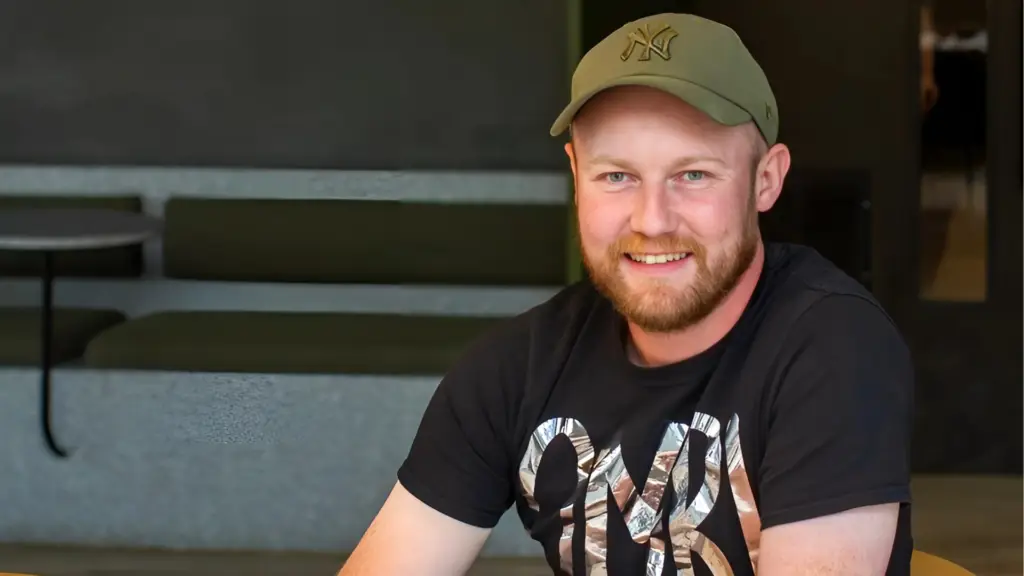 Nick Entwistle wearing a cap and One Minute Briefs t-shirt