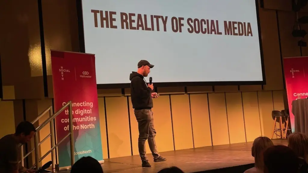 Nick Entwistle speaking on stage about the reality of social media