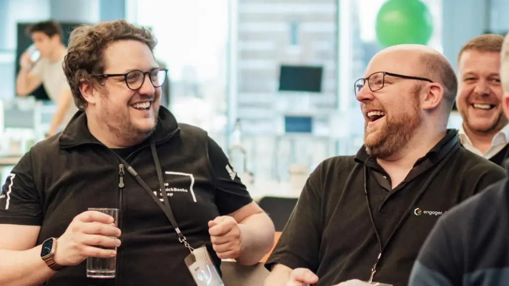 Johann Goree laughing with colleagues at an event