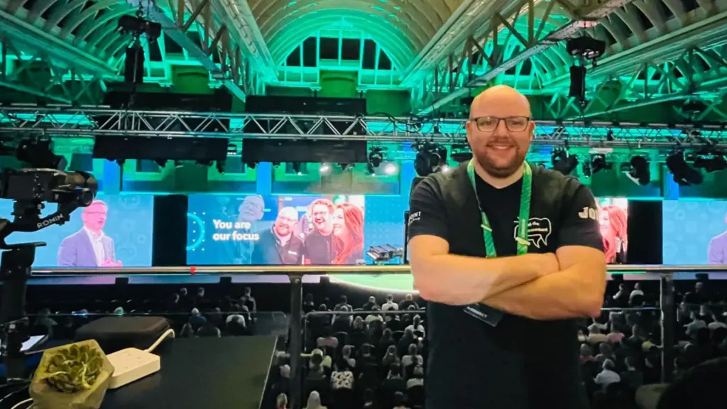 Johann Goree at an event venue with green stage lighting