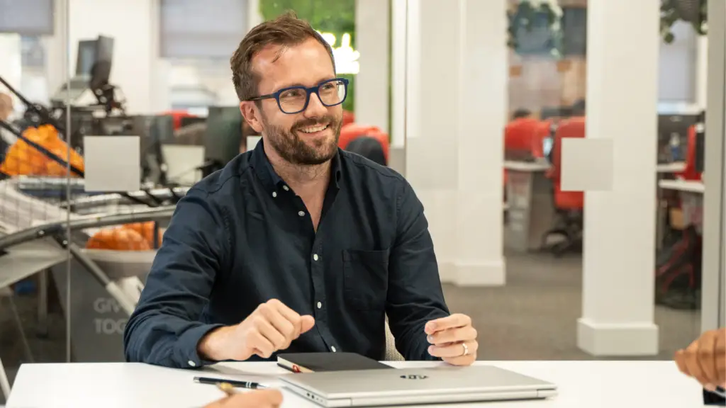 Sam Tasker-Grindley of Nexus smiling at his desk