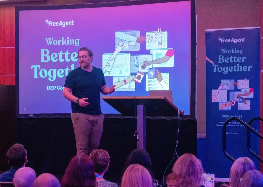 Stu McEwan presenting on stage at a FreeAgent Working Better Together event