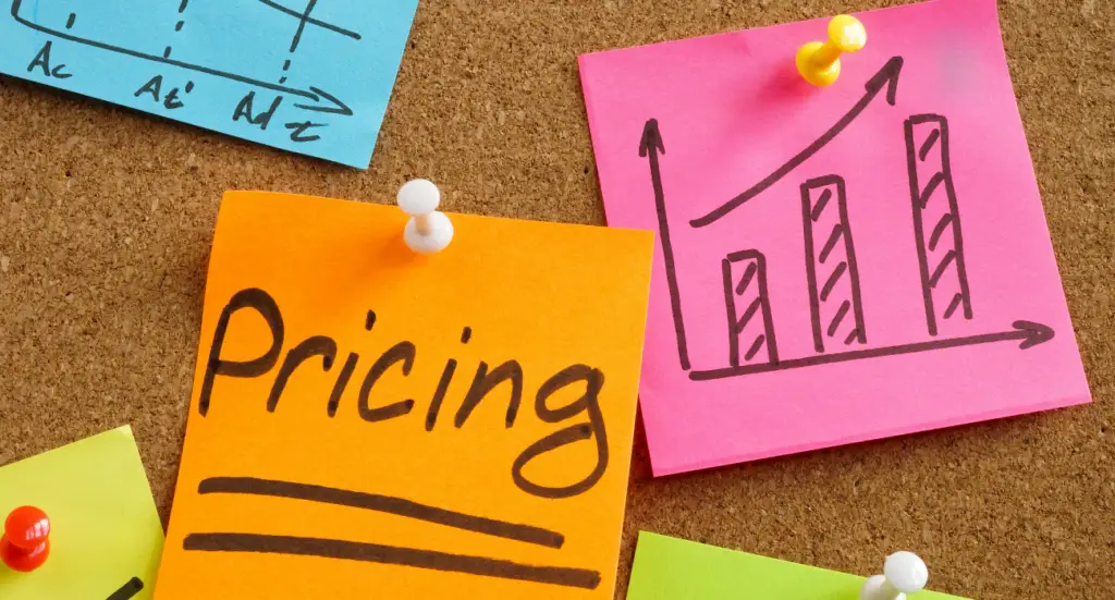 Sticky notes on a corkboard, one reading pricing