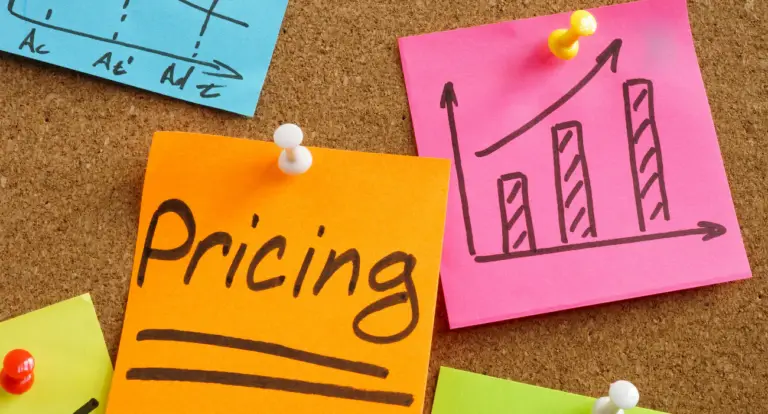 Sticky notes on a corkboard, one reading pricing