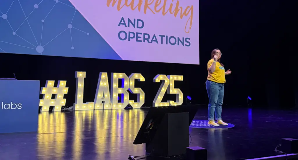 Karen Reyburn of We Are PF presenting on stage at Engager LABS 2025