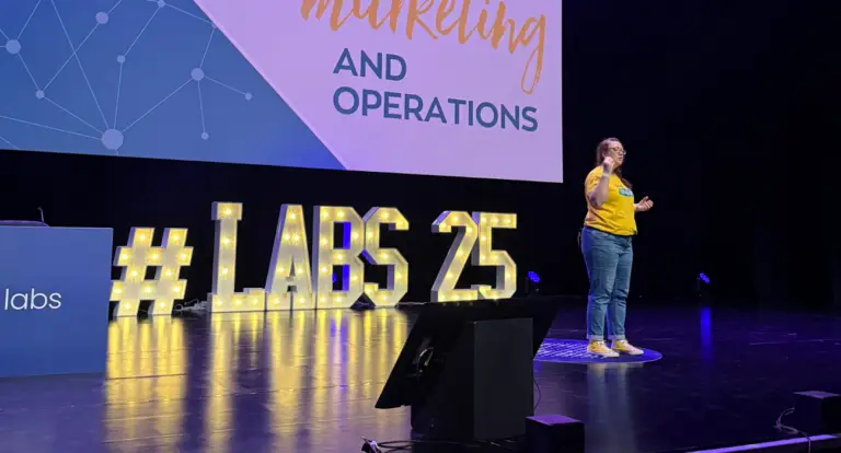 Karen Reyburn of We Are PF presenting on stage at Engager LABS 2025
